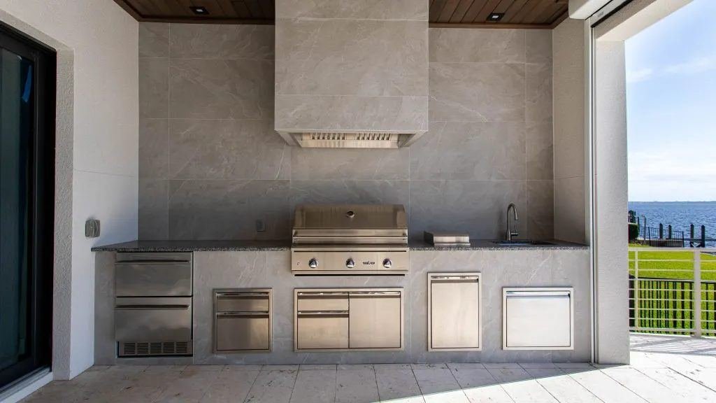 Waterfront outdoor kitchen with a vent hood